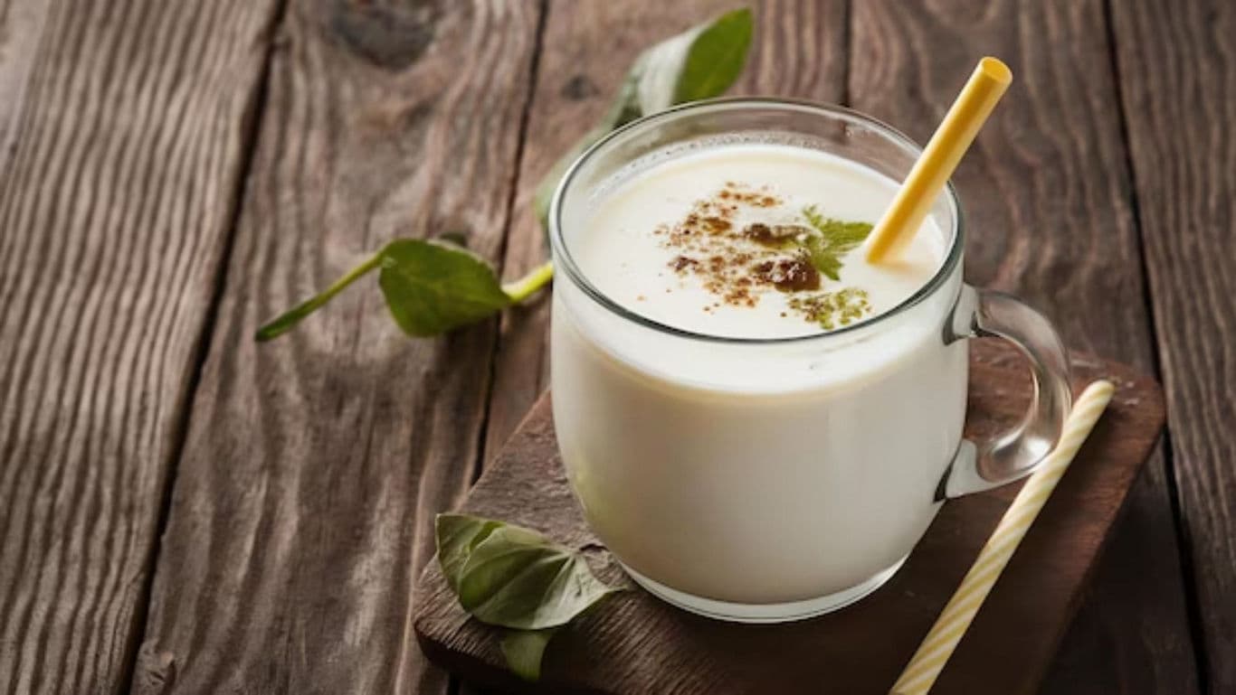 Traditional Spiced Buttermilk in Glass Mug on Wood