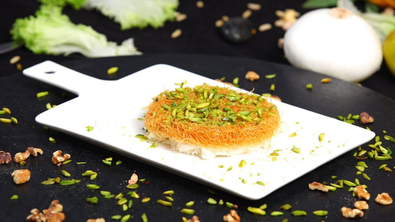 Middle Eastern dessert with pistachio topping on platter