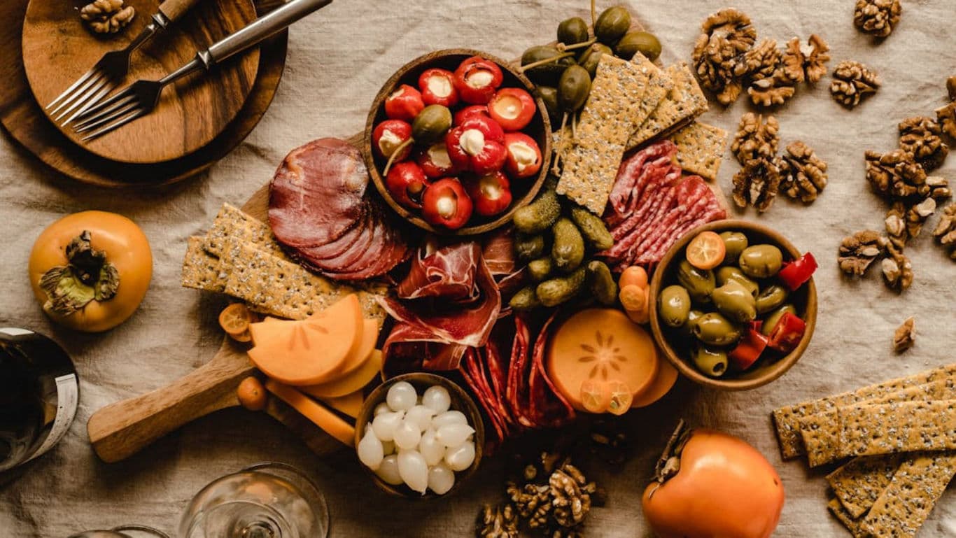 Rustic charcuterie board with fruits and crackers