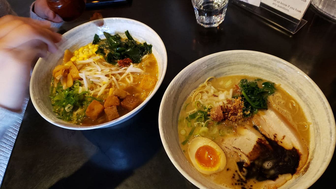Two bowls of ramen on restaurant table