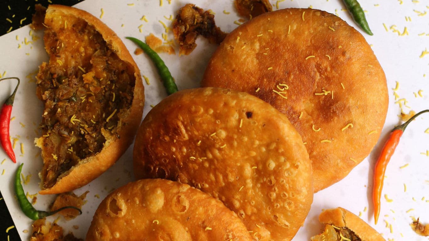 Crispy stuffed pastries with chili garnish