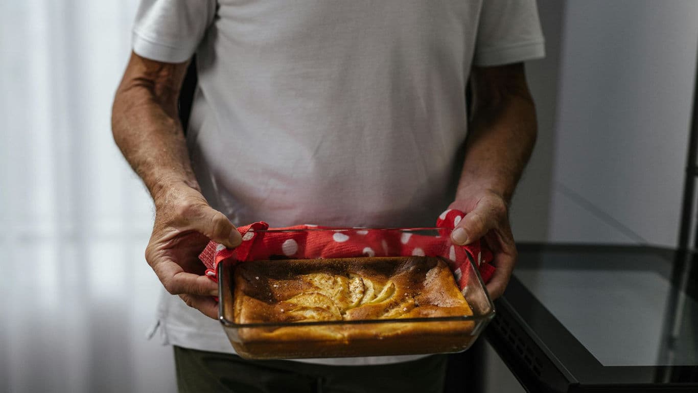Person holding freshly baked homemade cake
