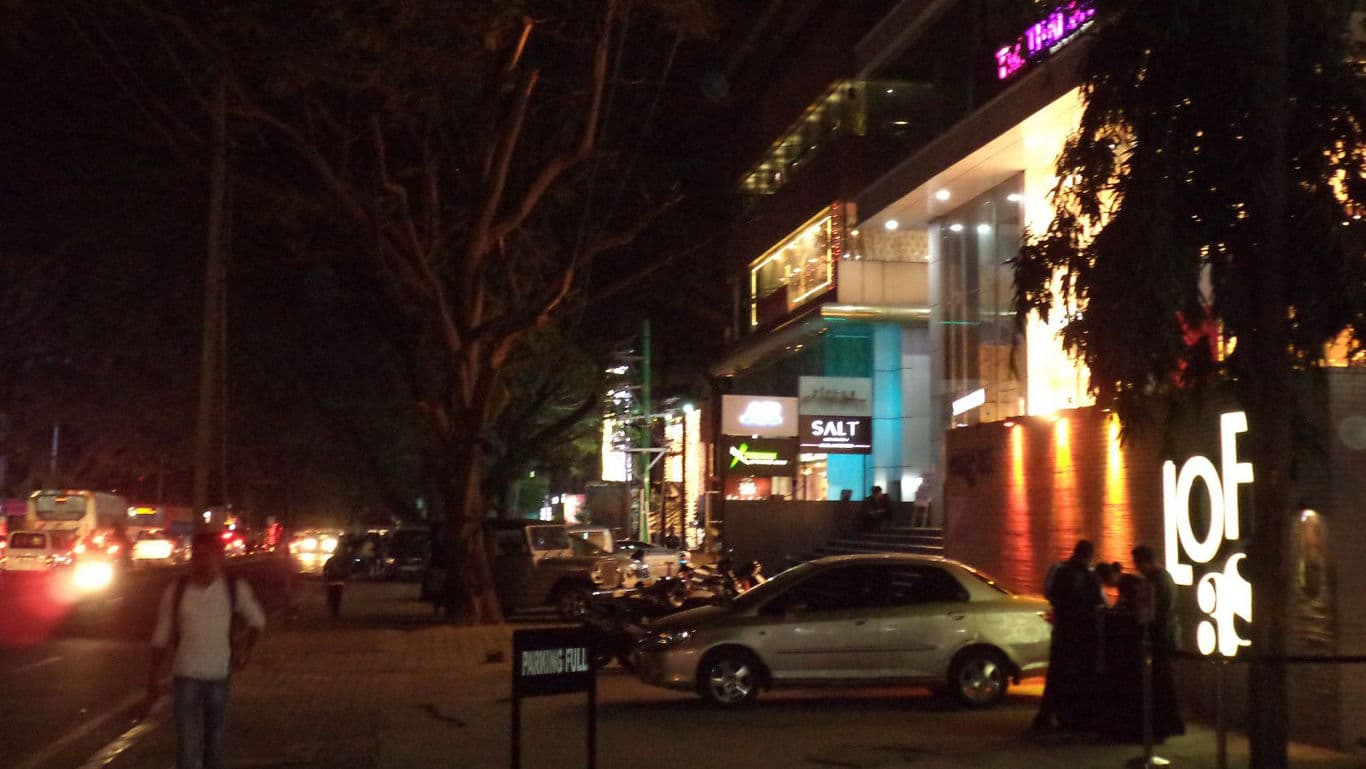 Busy city street with illuminated shops at night