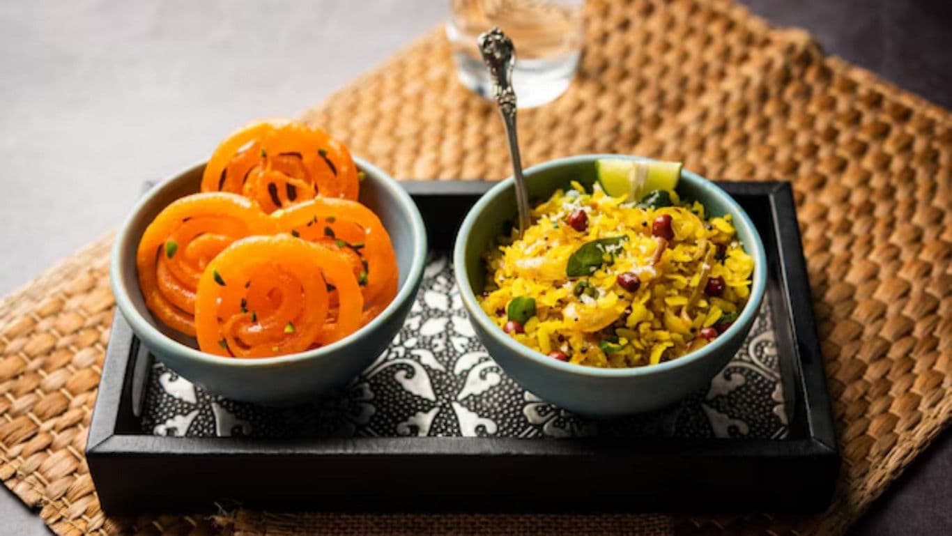 Traditional Indian breakfast with jalebi and poha served