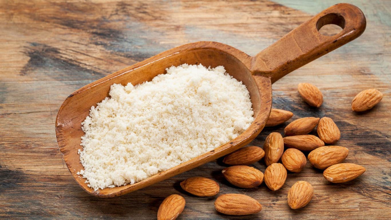Wooden scoop filled with ground almond flour
