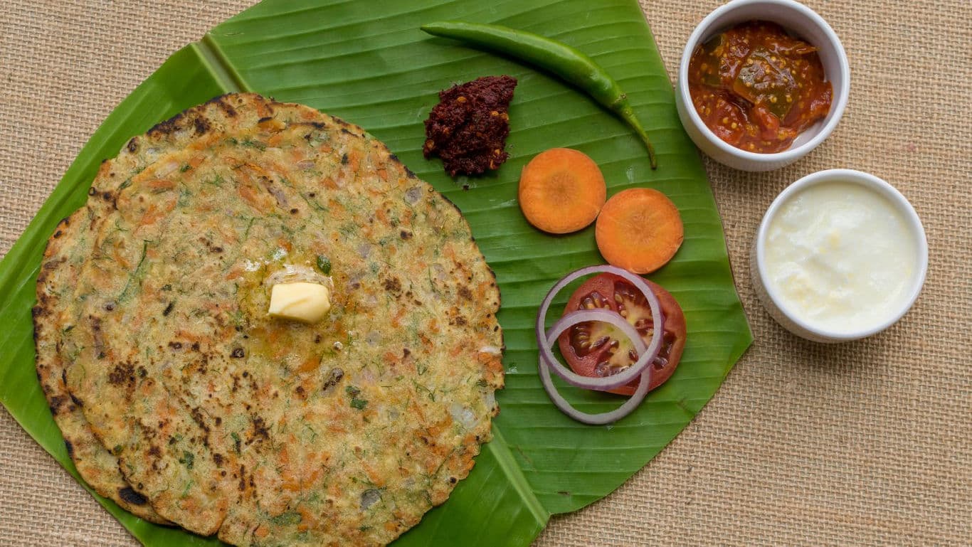 Indian flatbread with butter and assorted condiments