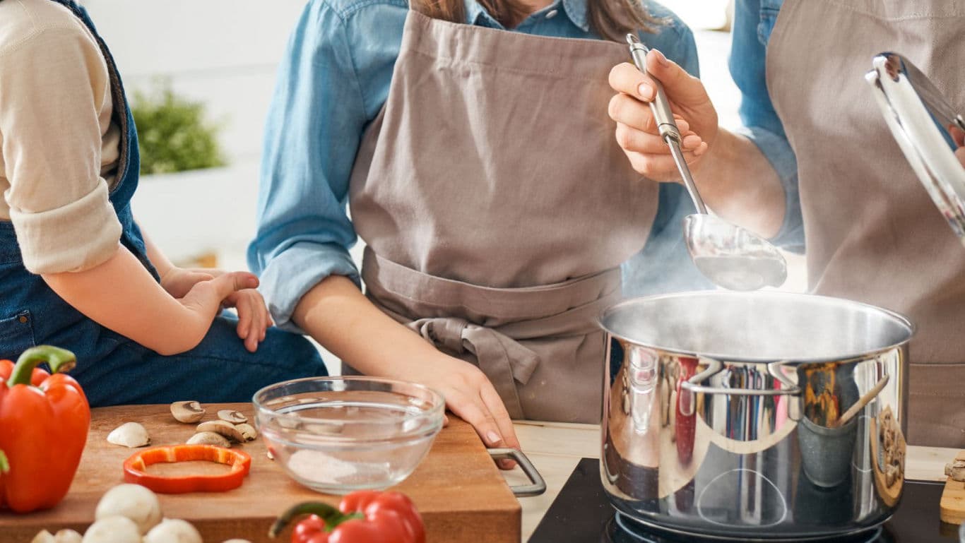 Family cooking together in cozy kitchen