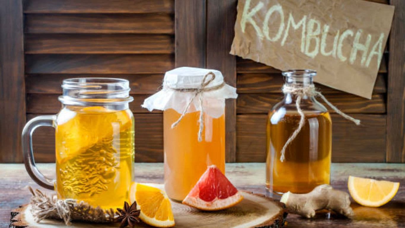 Homemade kombucha tea jars with citrus and ginger