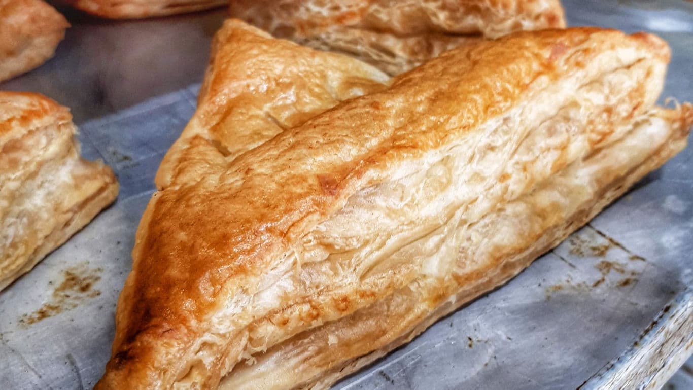 Golden flaky pastry on baking tray