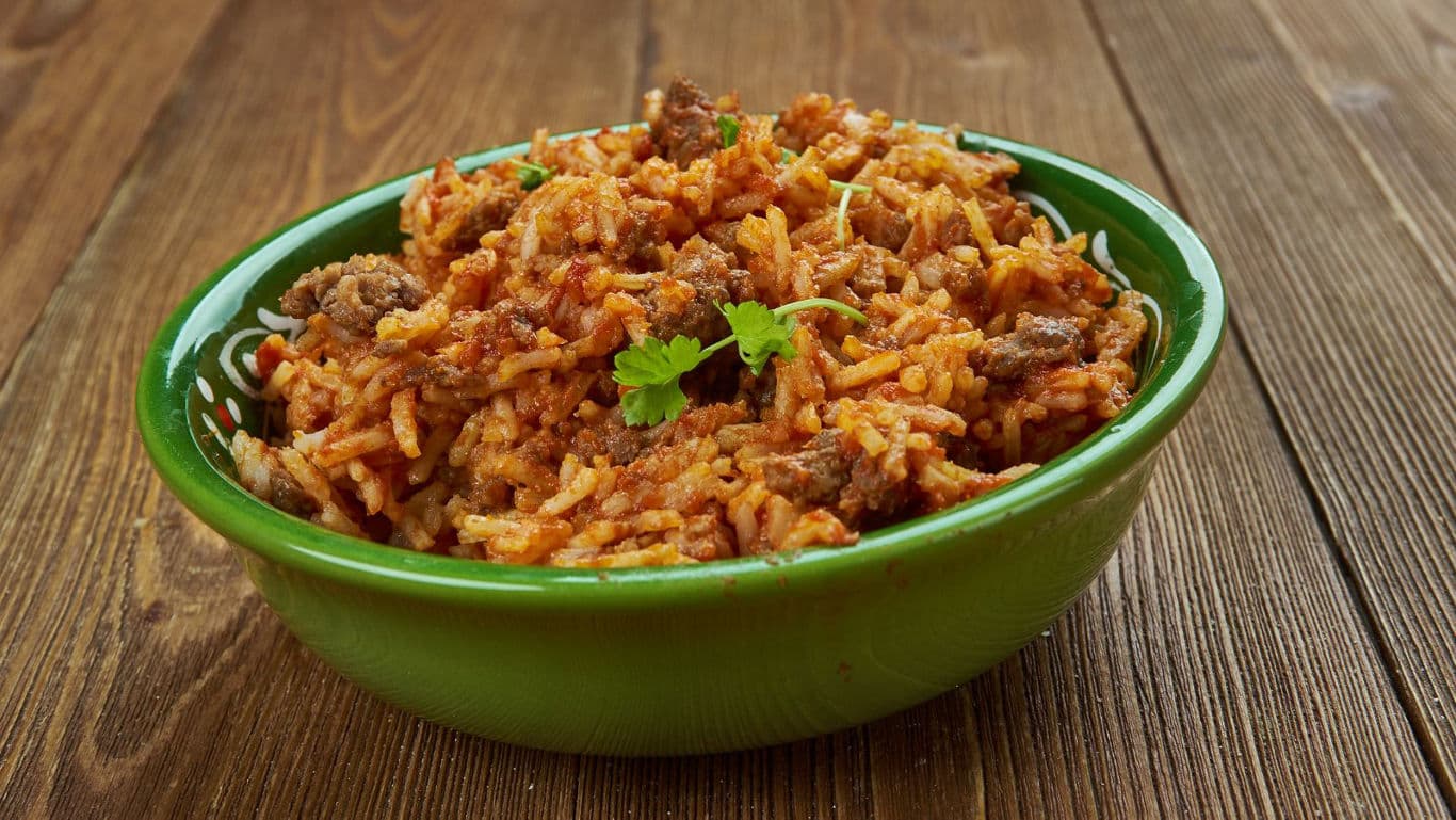 Spicy rice and beef dish in green bowl