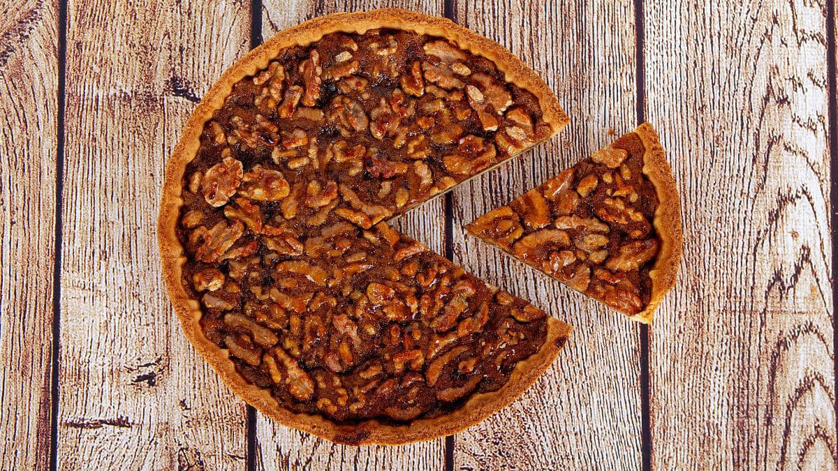 Jaggery and Nut Pie with a slice cut out