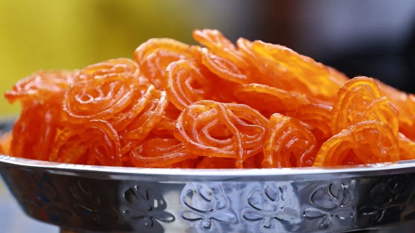 Close-up of orange jalebi in a bowl