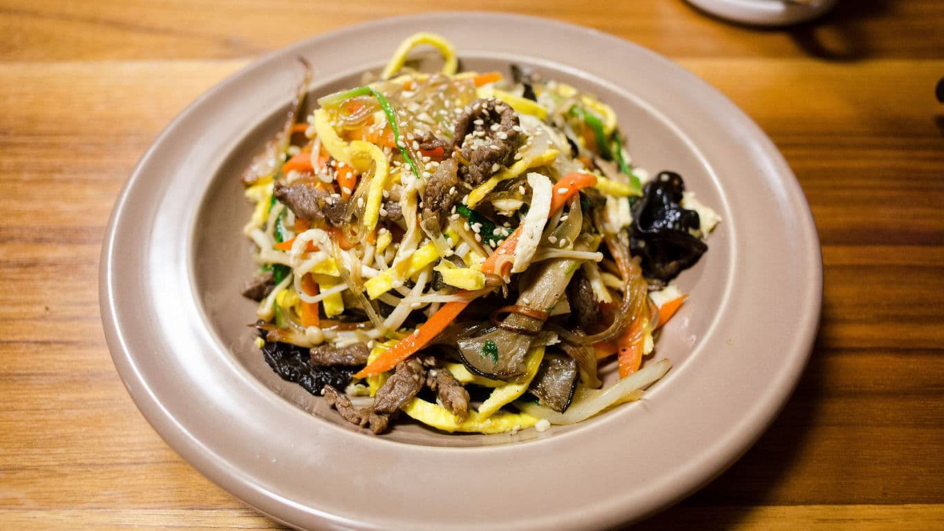 Colorful stir-fry dish on wooden table