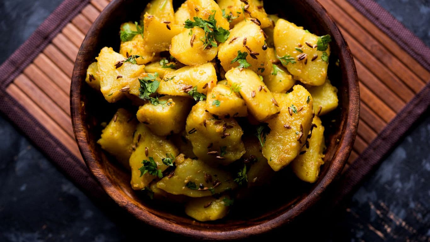 Spiced Potato Chunks in Wooden Bowl Overhead