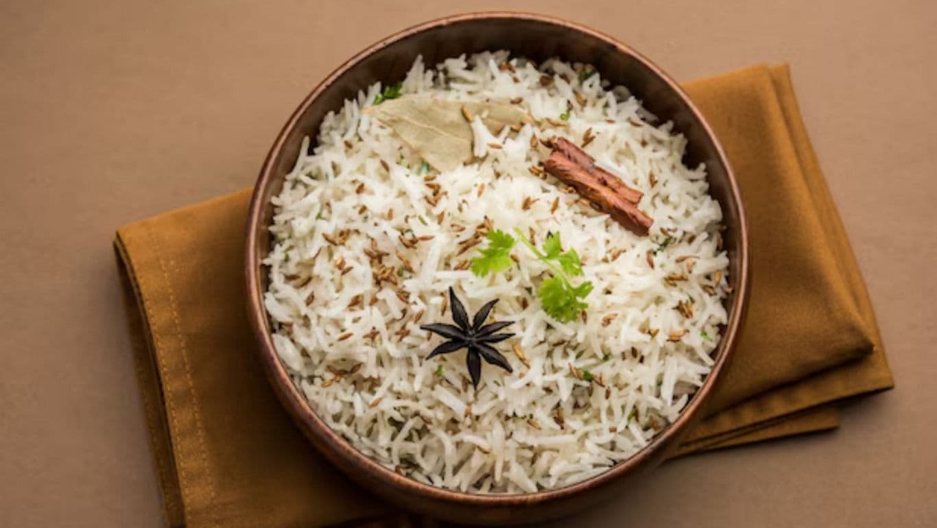 Bowl of spiced basmati rice on brown cloth