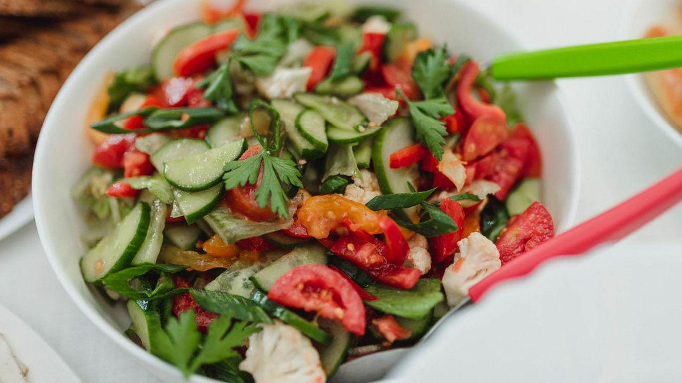Fresh vegetable salad in white bowl