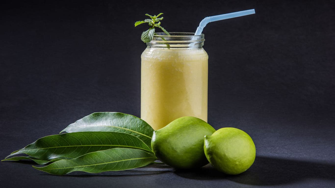 Fresh mango smoothie in glass jar