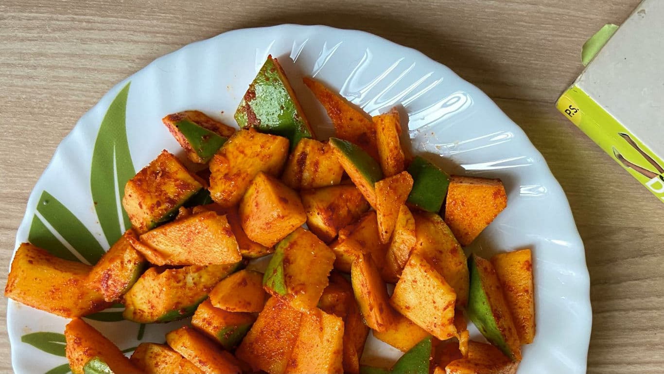 Spicy Mango Slices on White Plate Over Table