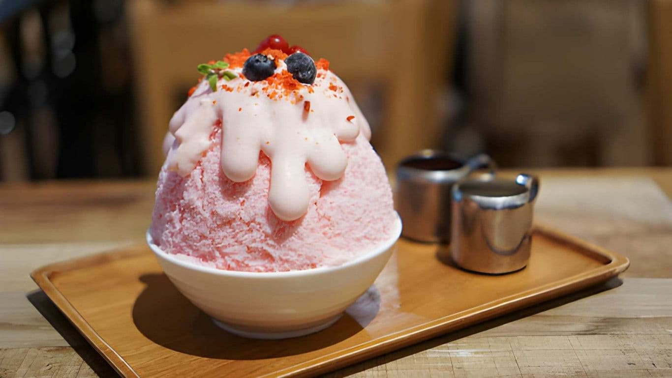 Strawberry shaved ice dessert with berries topping