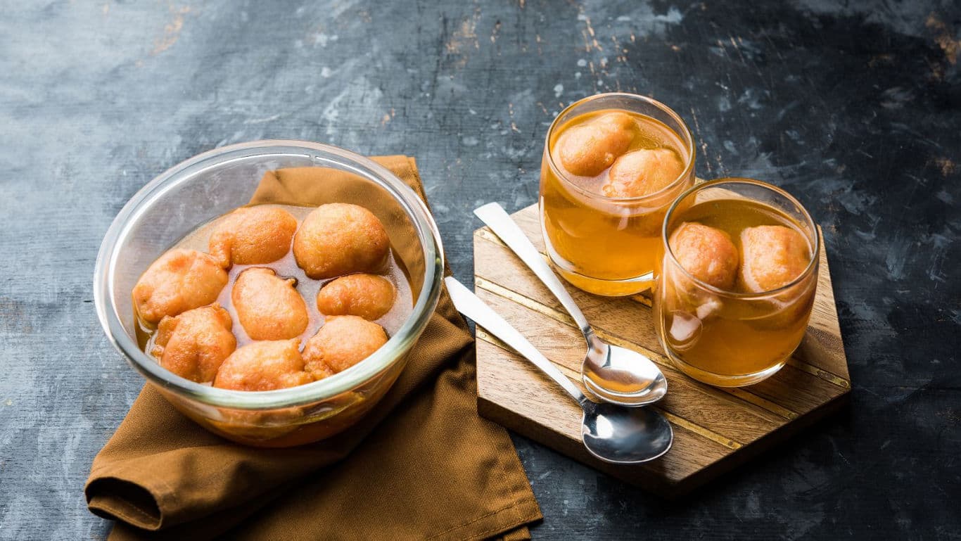 Indian dessert gulab jamun served in glass bowls