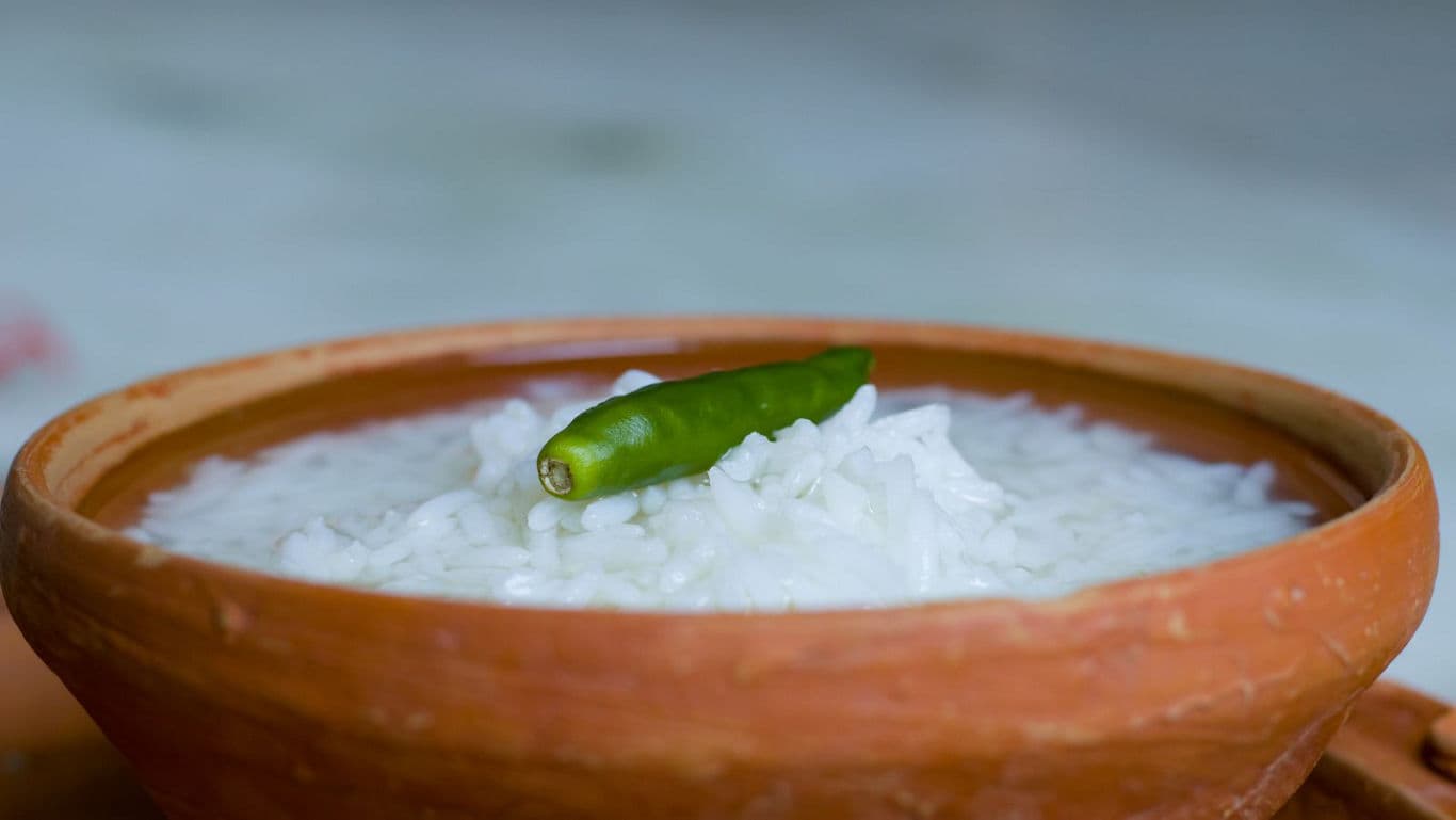 Clay bowl of rice with green chili