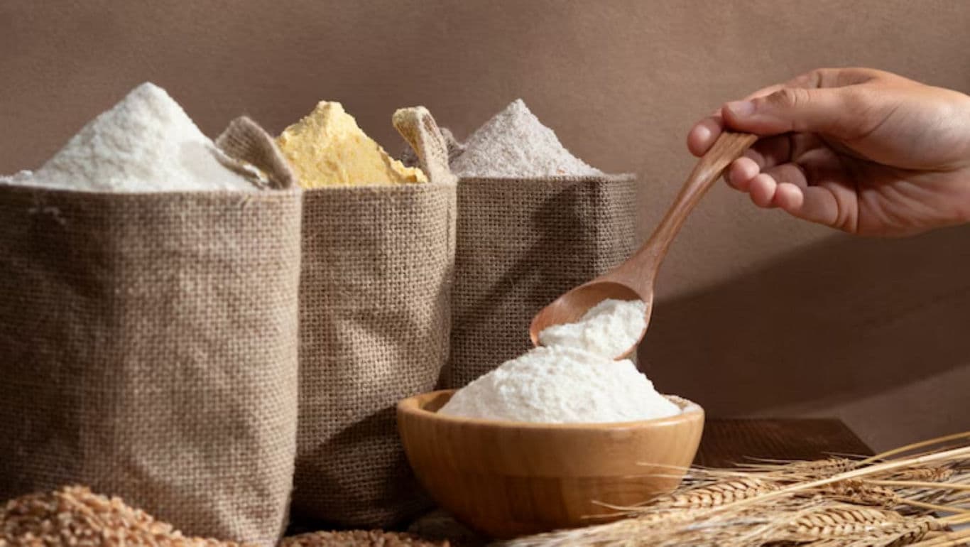 Assorted flours in burlap sacks with wooden spoon