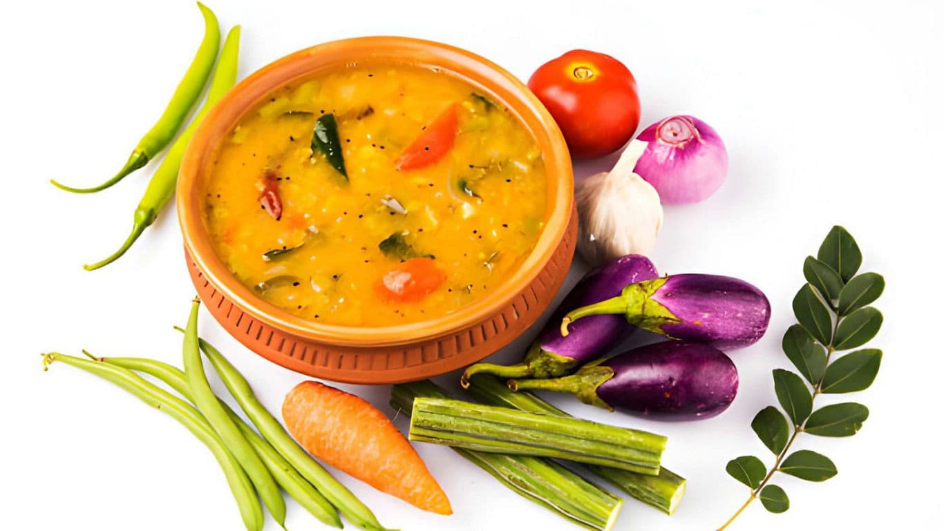 South Indian sambar with fresh vegetables on white background