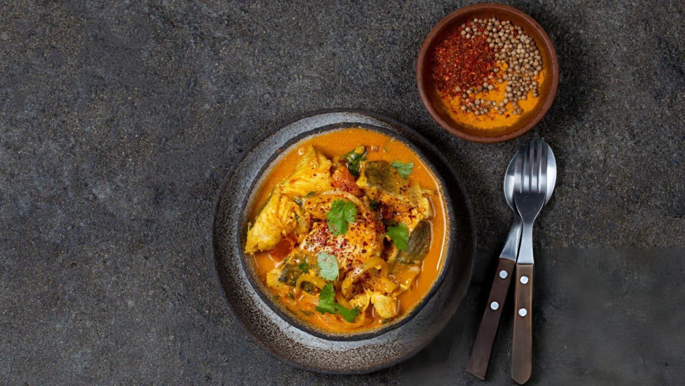 Kerala fish curry with spice blend on the side.