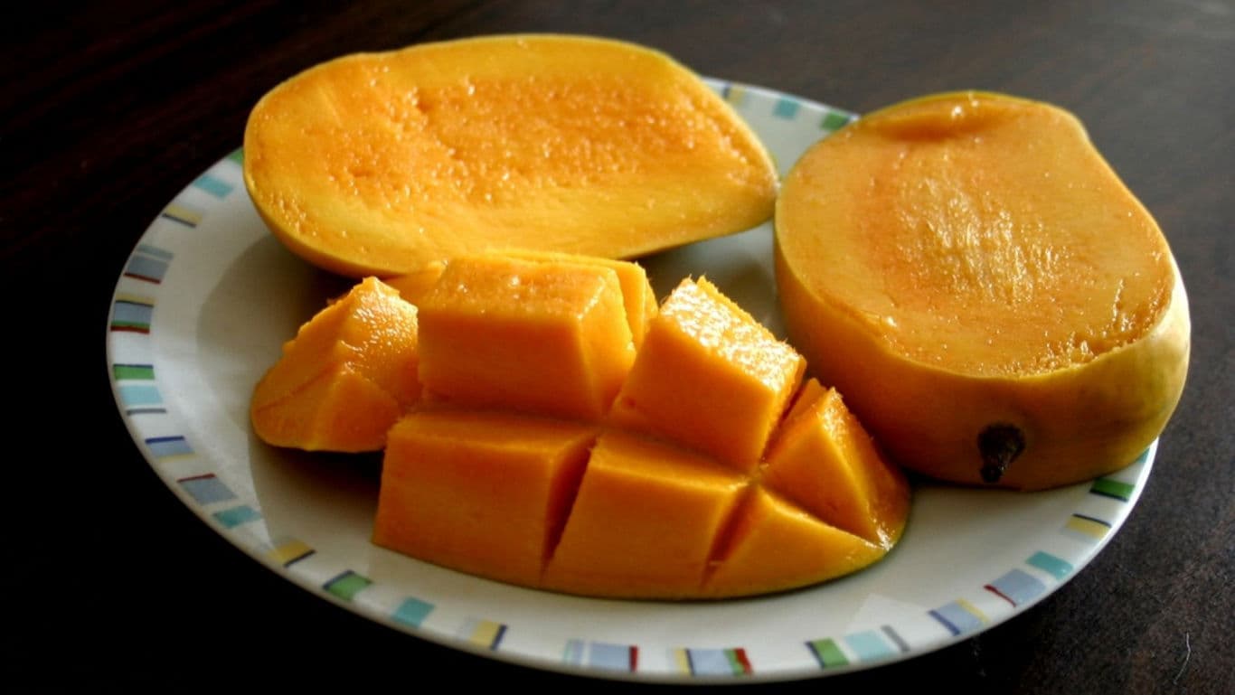 Fresh ripe mango slices on plate