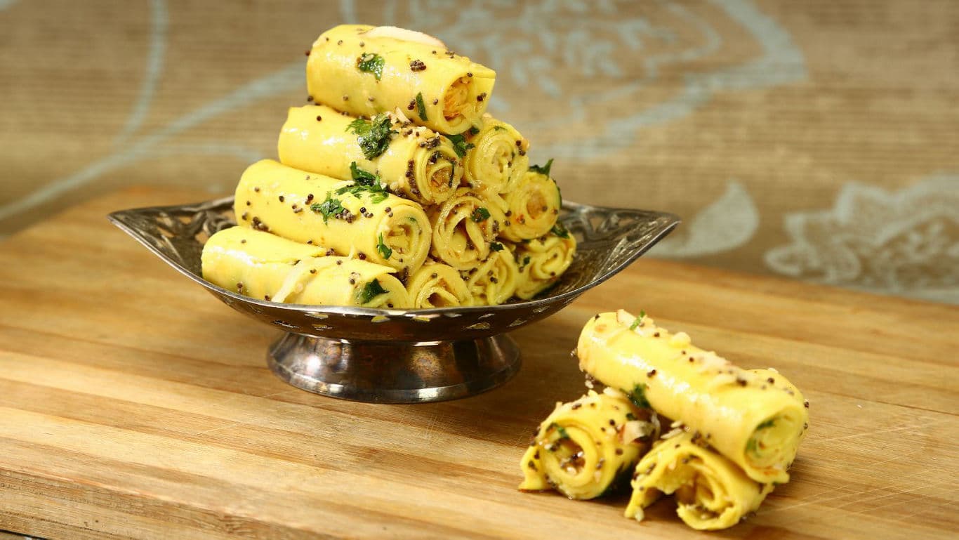 Stack of rolled savory snacks on wooden table