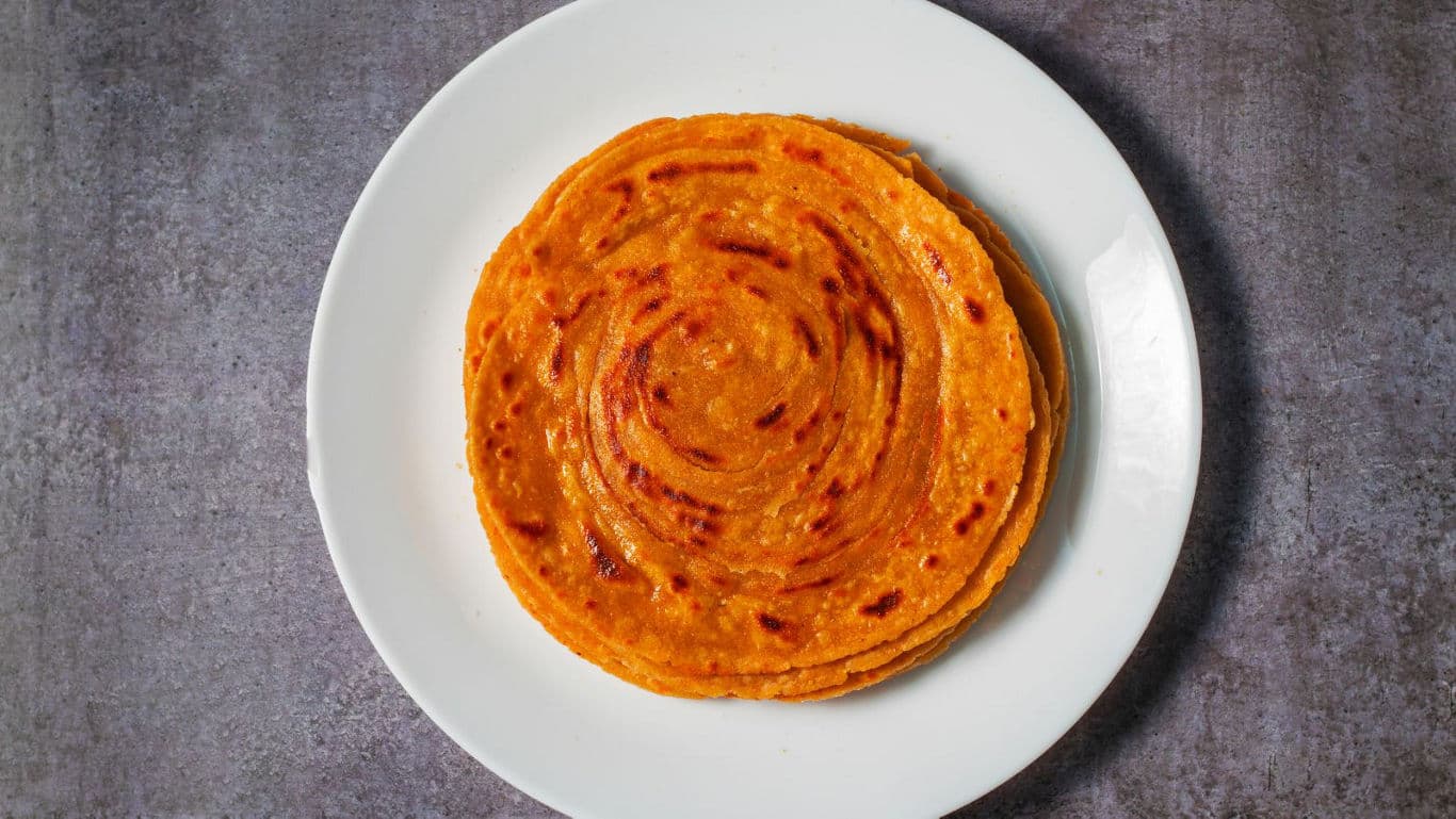 Stack of layered parathas on plate