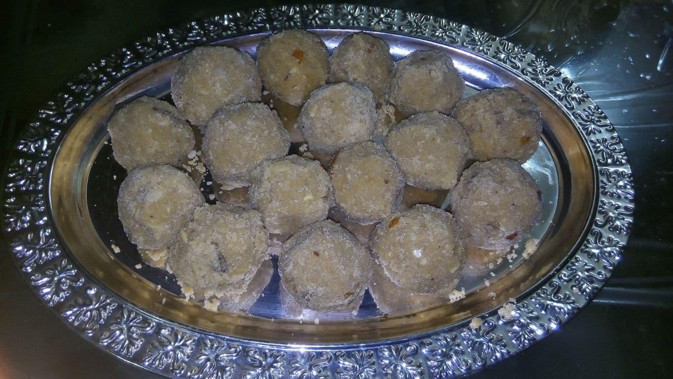 Traditional sweet ladoos on ornate silver tray