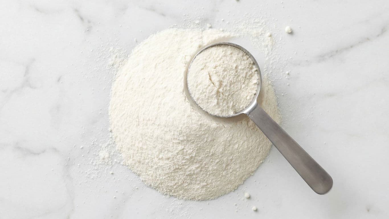 Scoop of white powder on marble surface