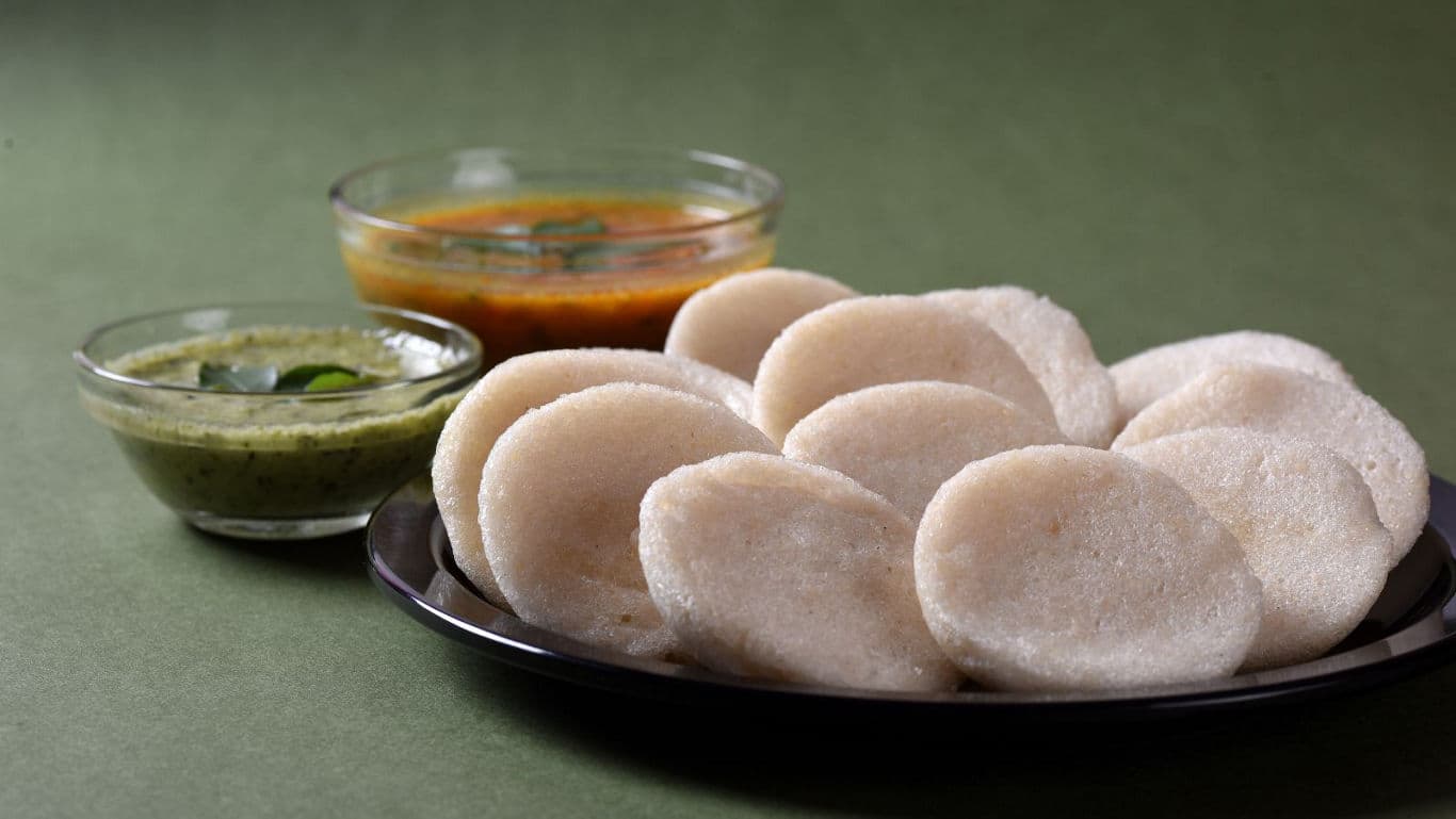 South Indian idli with chutney and sambar on plate