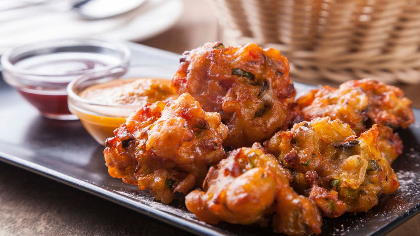 Crispy vegetable fritters served with dipping sauces