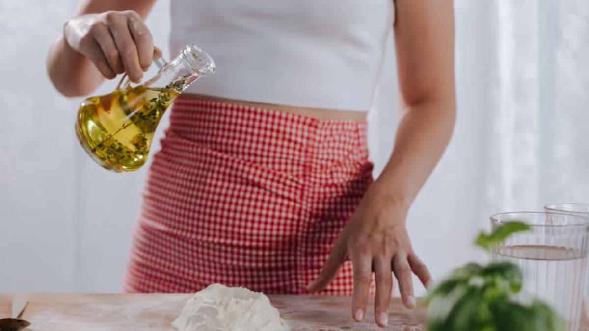 woman pouring olive oil