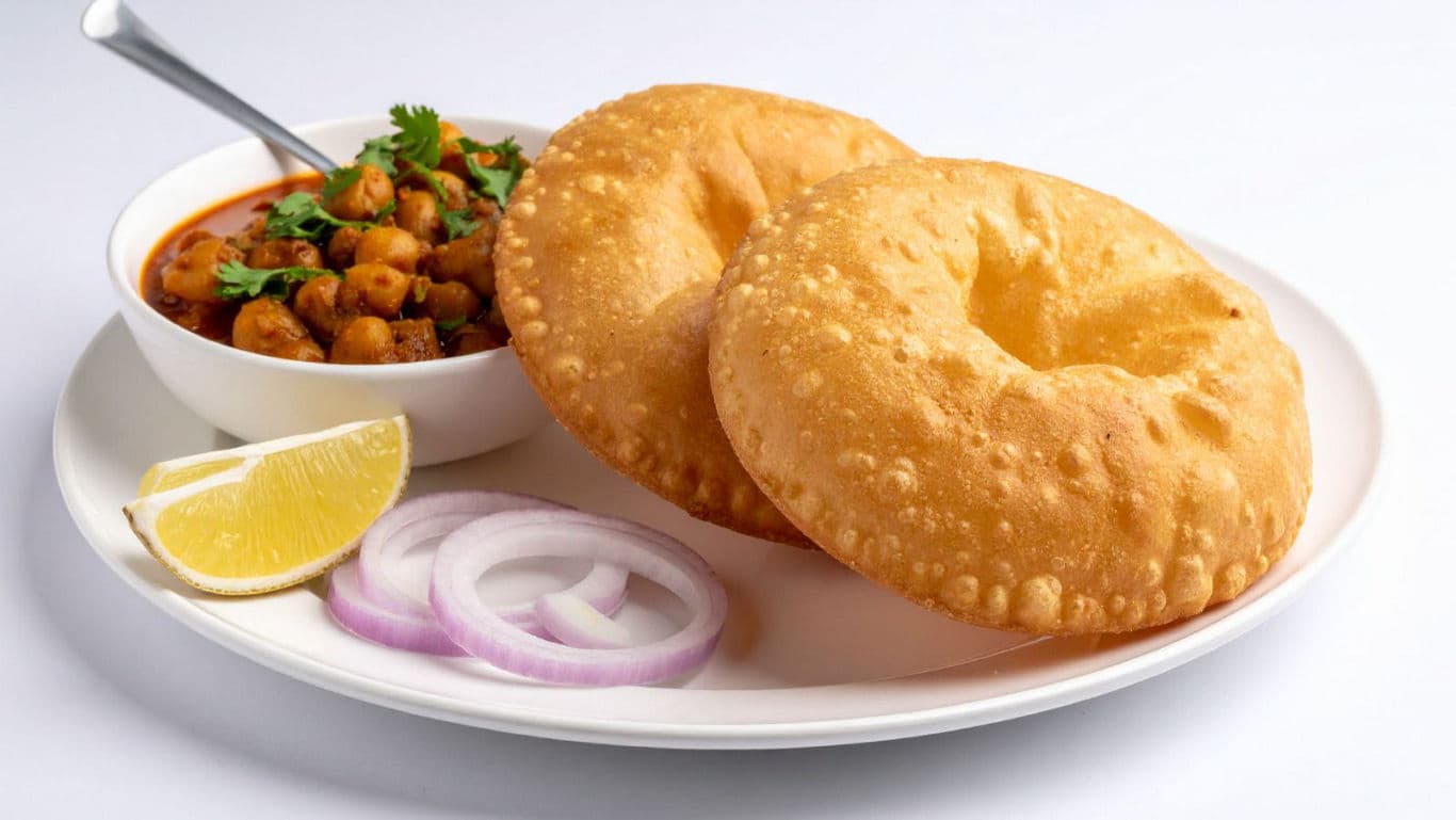 Indian chole bhature meal with onions and lemon
