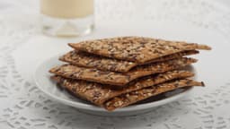 Khapli wheat-flaxseed crackers stacked on a plate