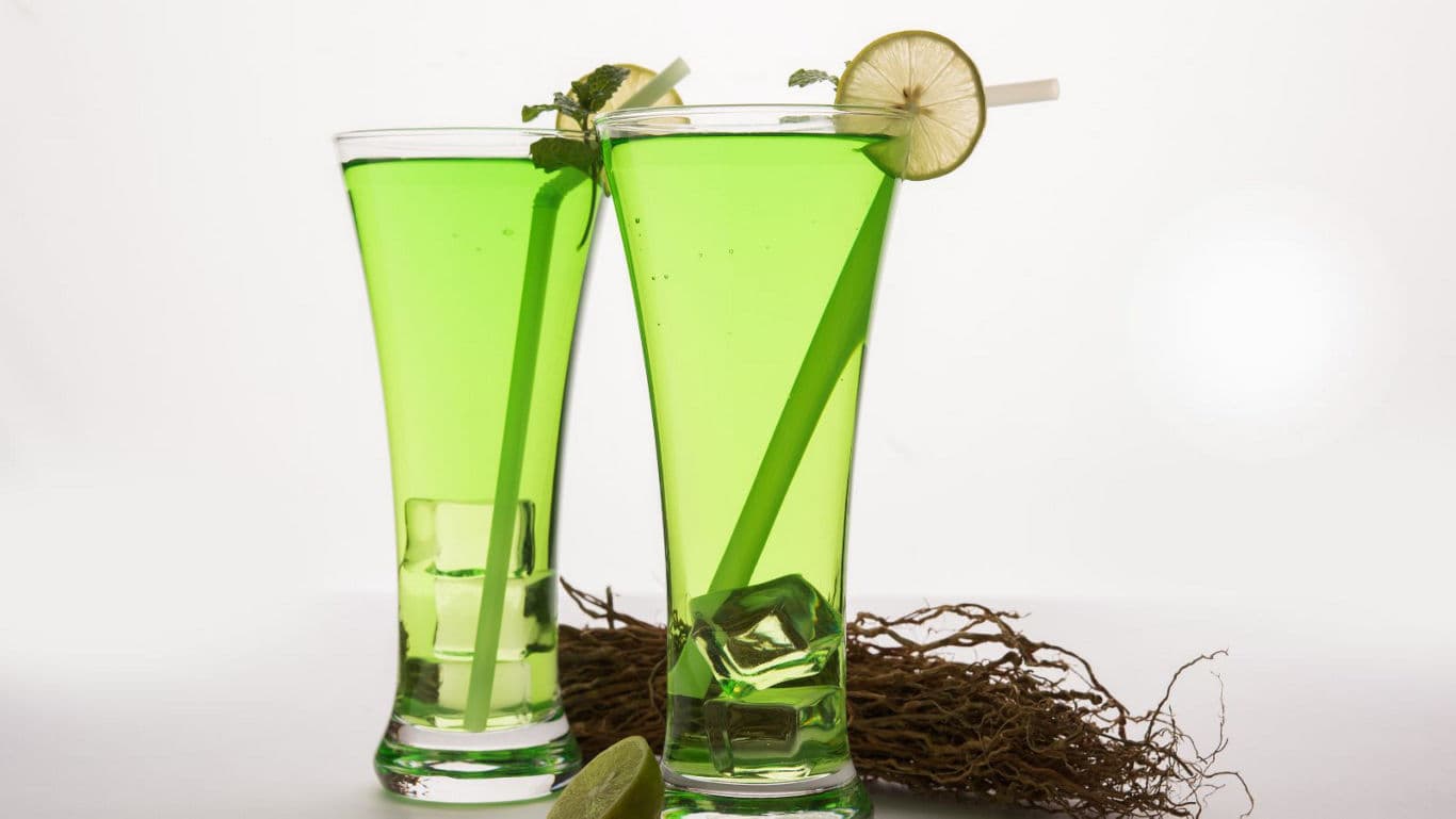 Two tall glasses of green drink