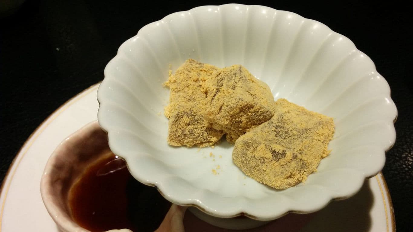 Japanese mochi dessert with kinako powder and syrup