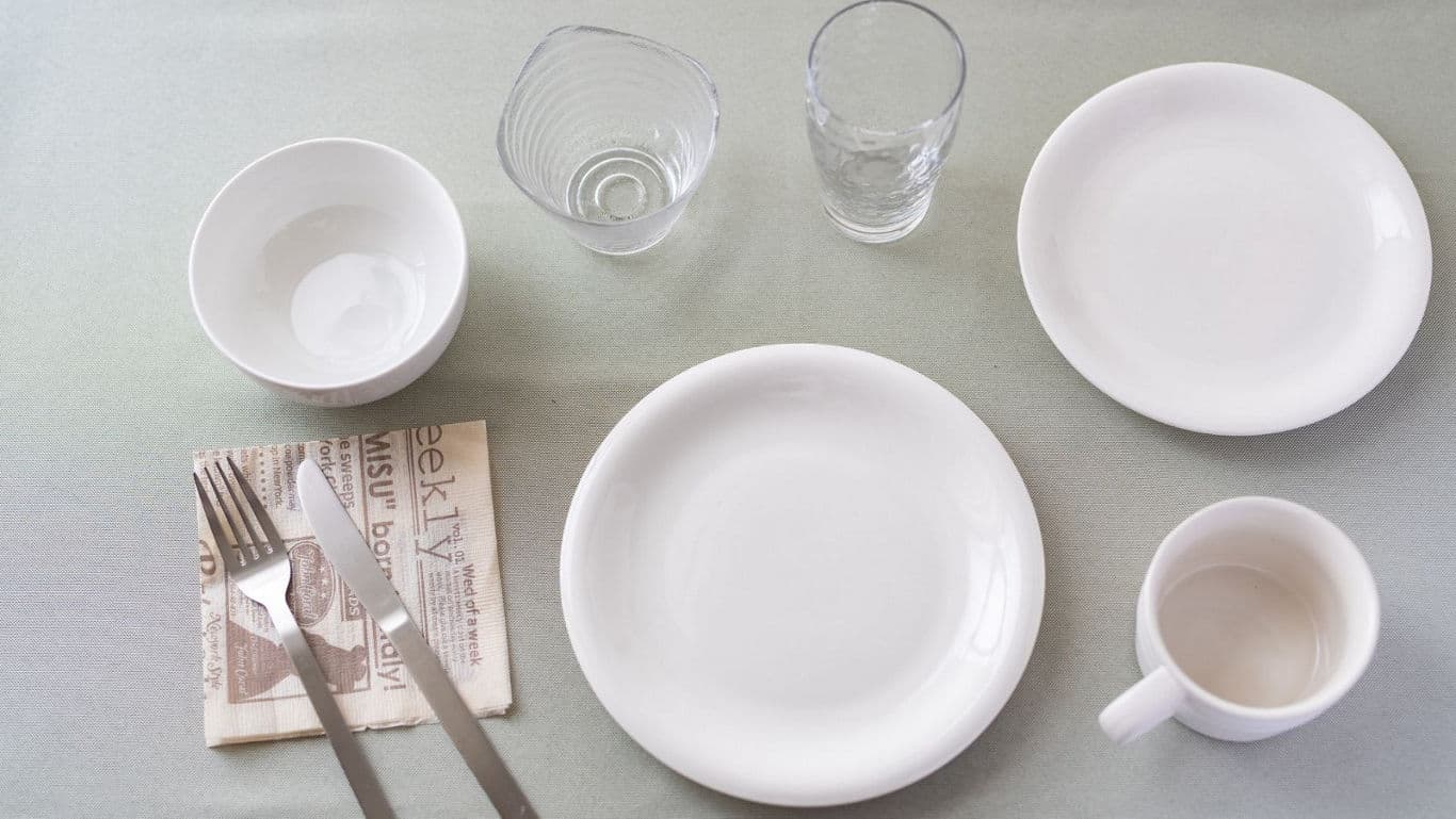 Minimal table setting with white dishes