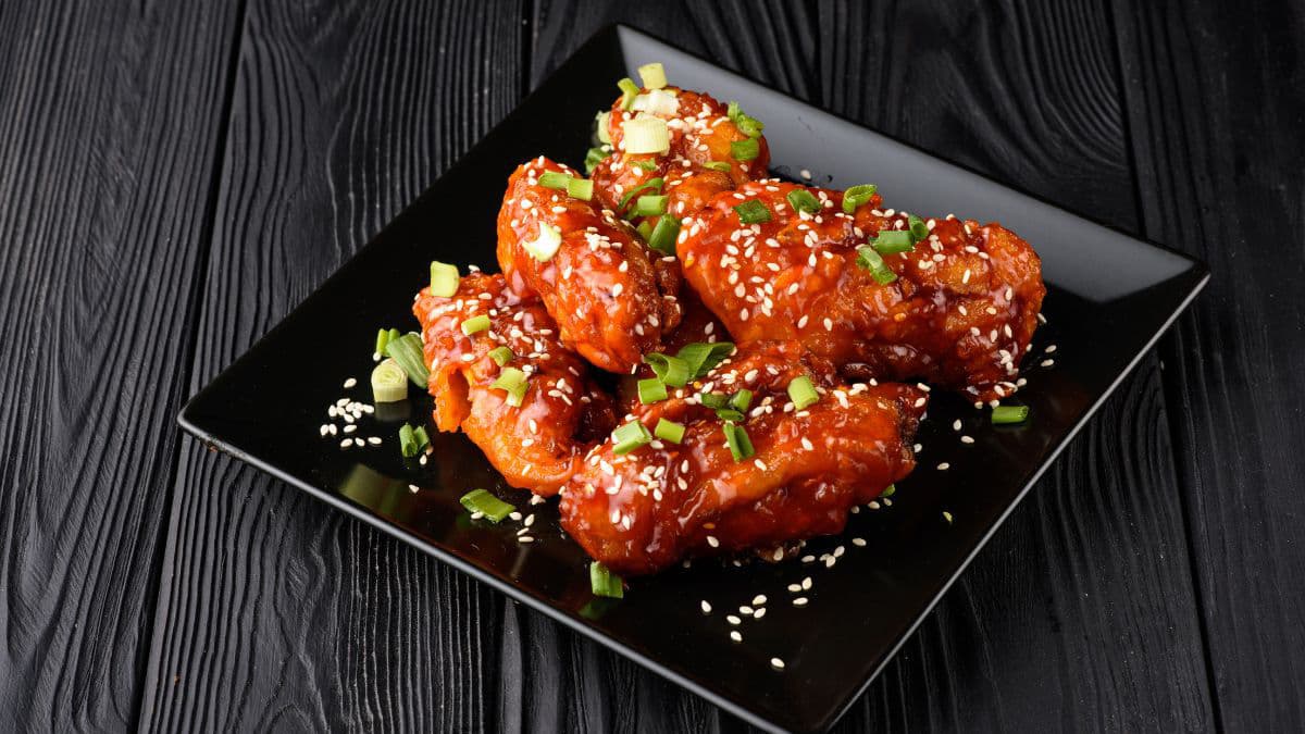 Korean fried chicken on a black plate