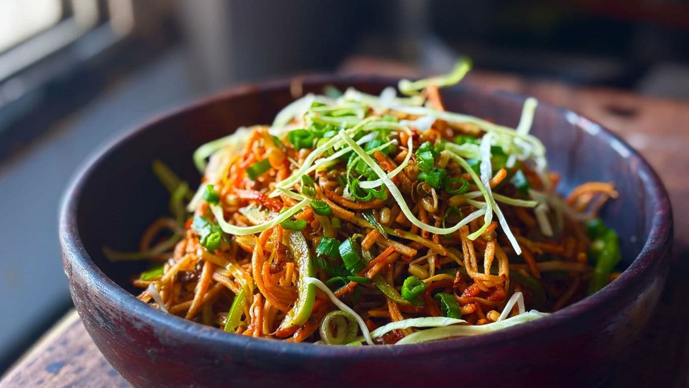 Spicy stir-fried noodles with fresh garnish