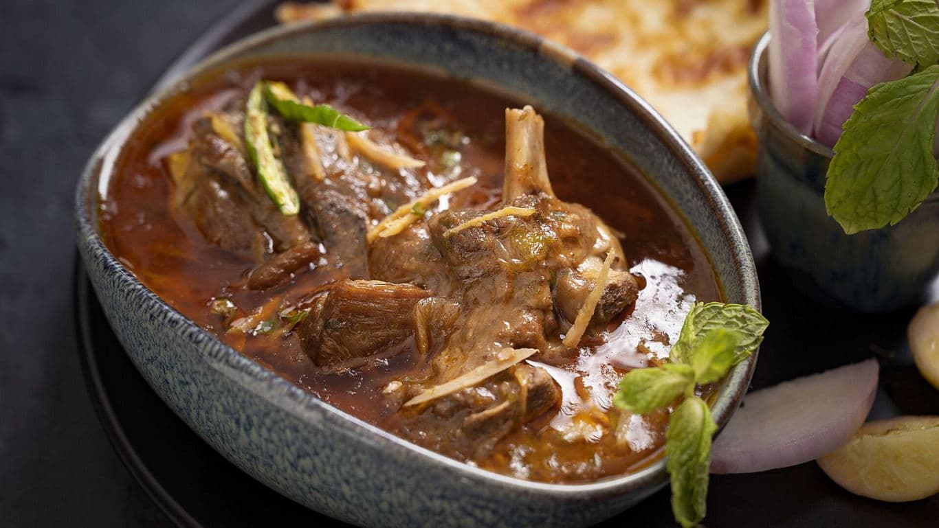 Spiced Lamb Curry with Fresh Garnish in Bowl
