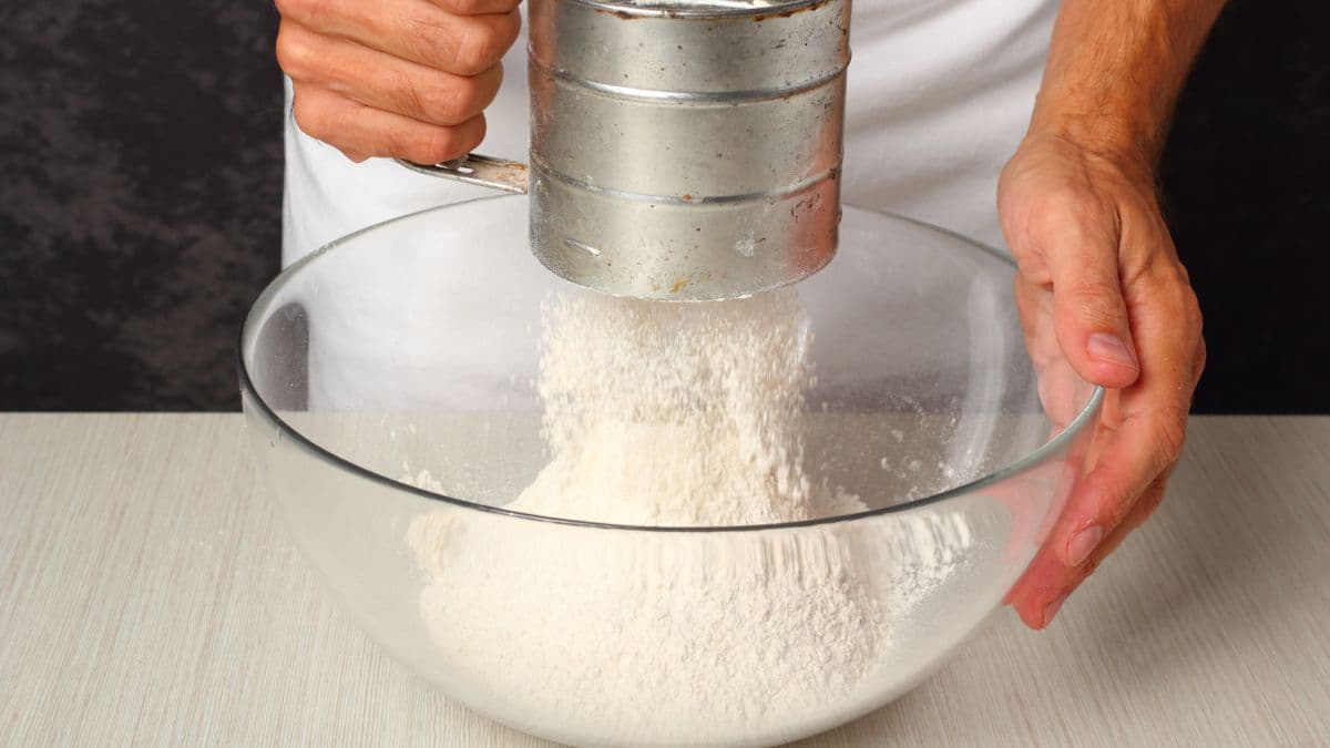 Flour being added to a bowl