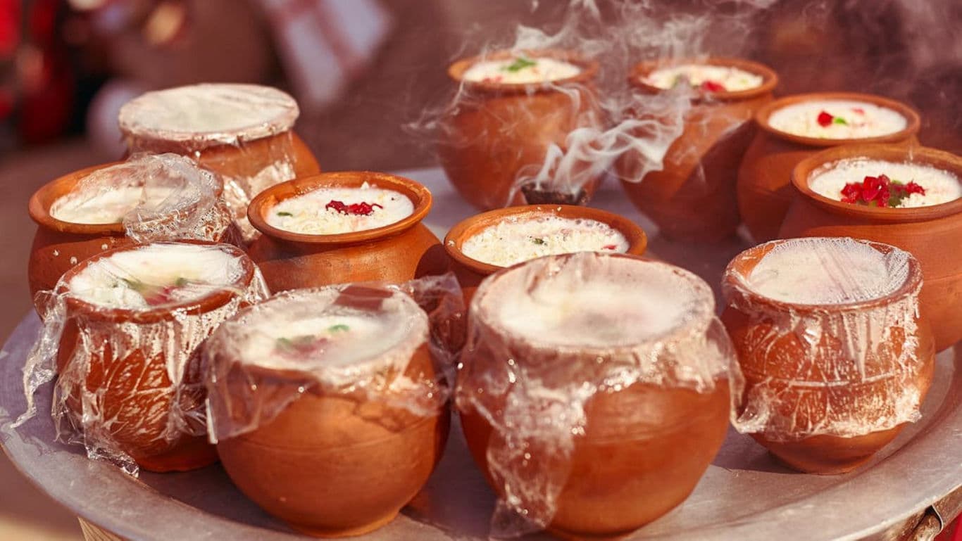 Traditional Clay Pots with Steaming Indian Dessert