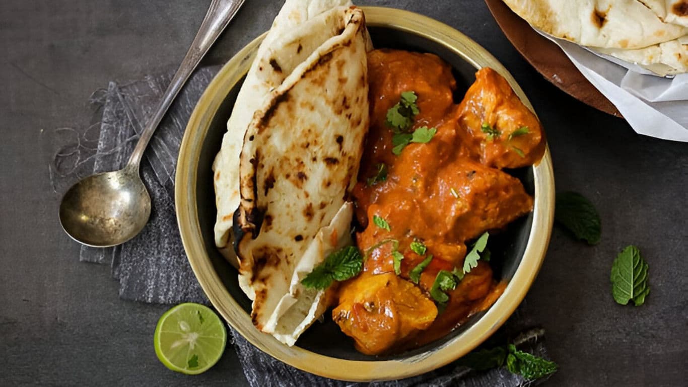 Indian Butter Chicken with Naan and Fresh Herbs