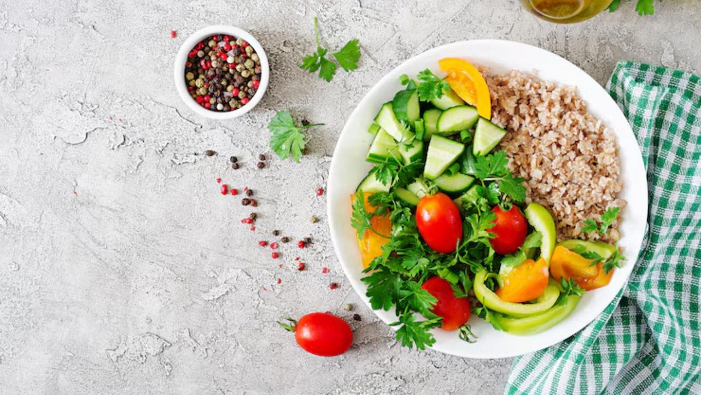 Fresh vegetable salad with grains on table