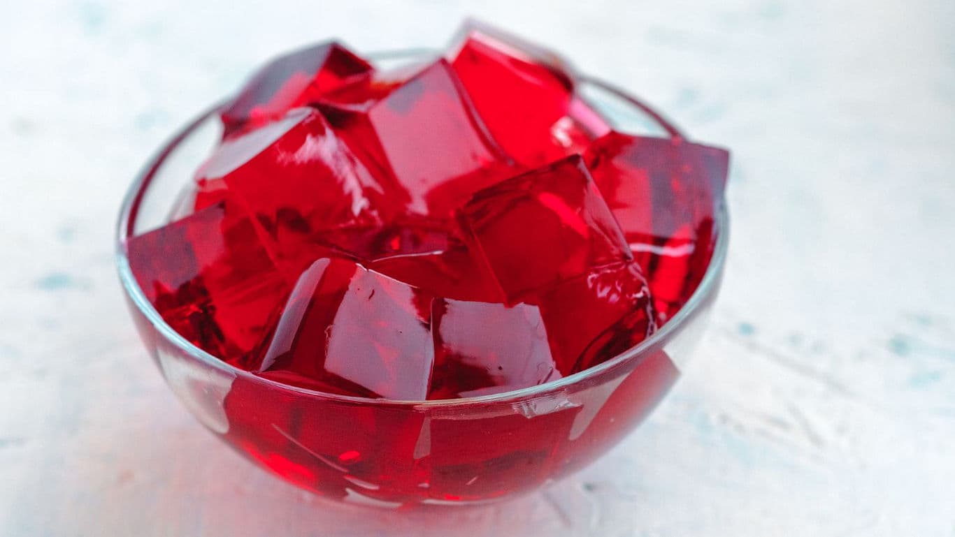 Glass bowl filled with red gelatin cubes