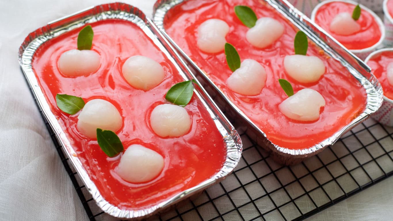 Lychee dessert in foil trays on rack
